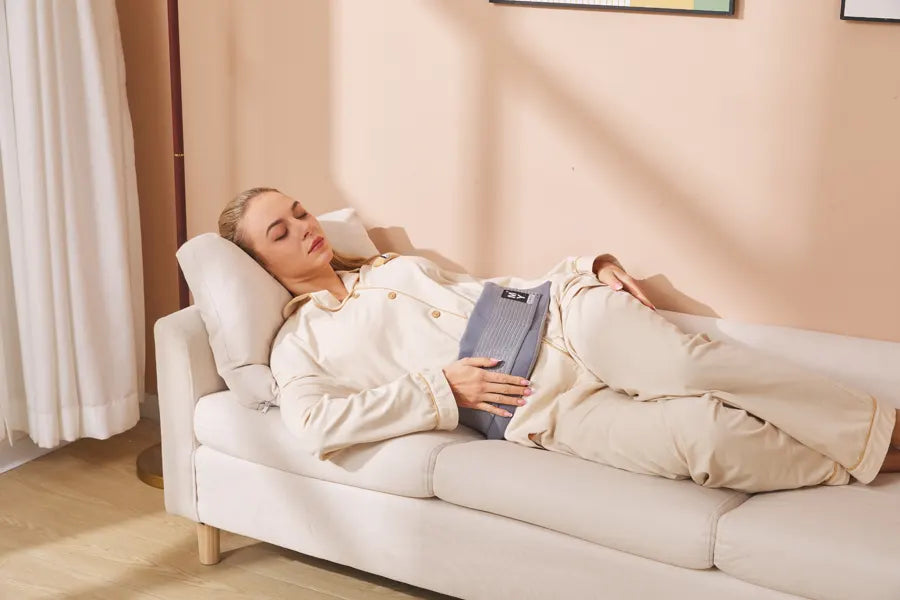 Woman relaxing on a sofa wearing an abdominal gel wrap